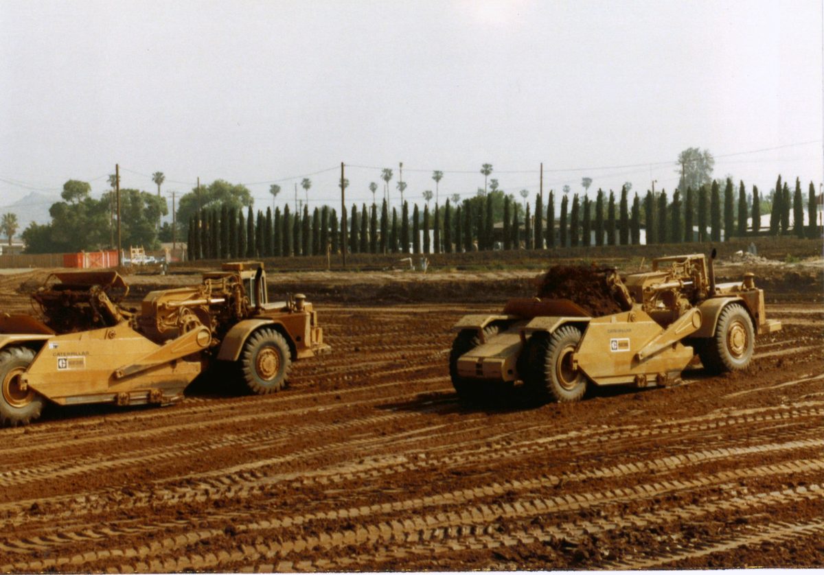 Two scrapers cutting and hauling in the early years
